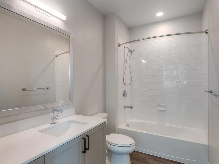 Scheme 2 bath with quartz countertop, hard surface flooring and modern fixtures