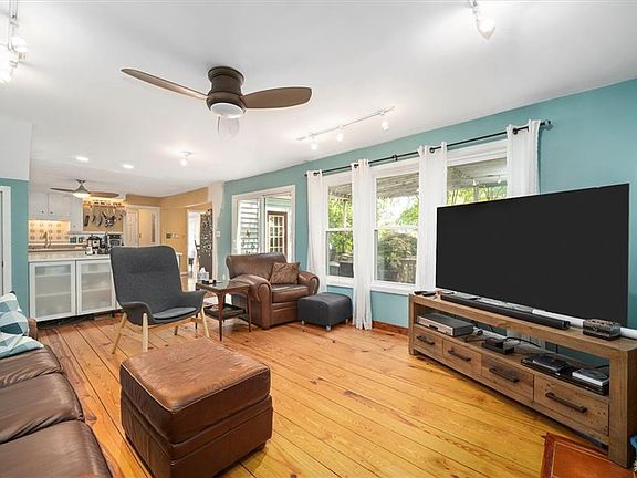 Spacious living room opens to kitchen.
