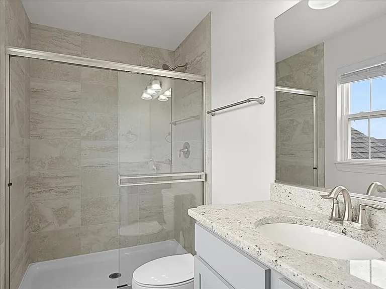 Second of four bedrooms with it's own attached full bathroom. Perfect for in law suite, care giver living arrangement, or guest room.