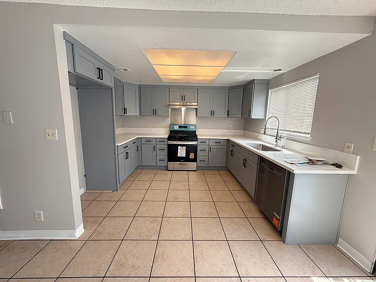 Completely new kitchen with new cabinets, new oven/range, new dishwasher, and new paint