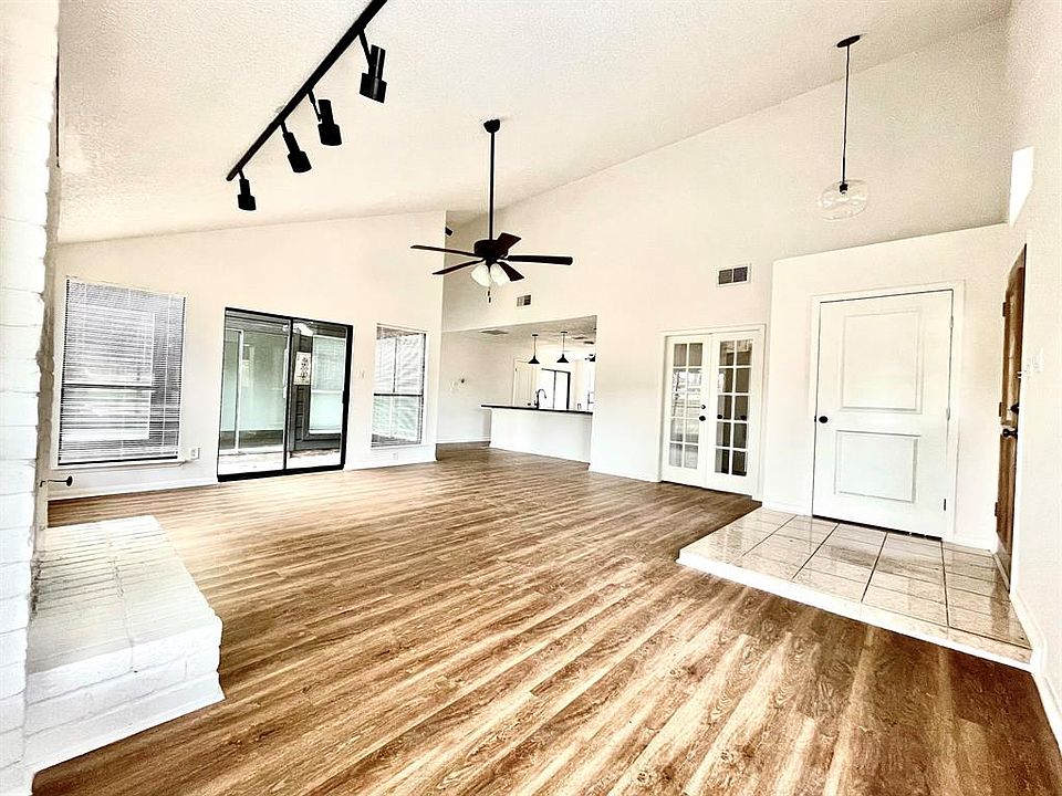 Open concept family room with brand new flooring and vaulted ceilings throughout the home!