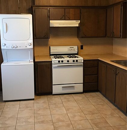Kitchen w/ washer and dryer unit included.