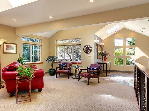 Follow the light from the gorgeous, open concept entry to the sun soaked living room with vaulted ceilings, windows galore, skylights, and wood burning fireplace. This home is warm and inviting and perfectly blends the new with old to create a treehouse like lodge.