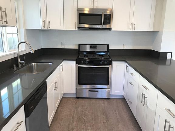 brand new white cabinet and stainless still appliances.