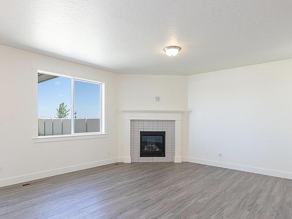 Spacious great room with fireplace and media connections.