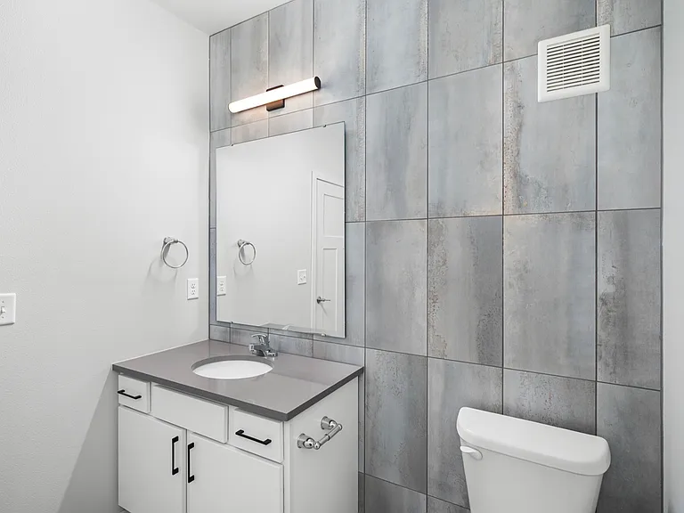 Modern bathroom with sleek tile design, stylish vanity, and contemporary fixtures. Modern bathroom with sleek tile design, stylish vanity, and contemporary fixtures.