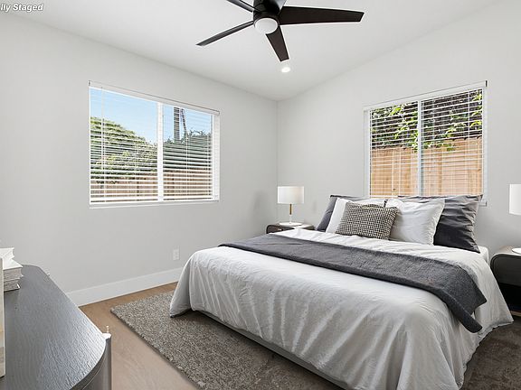 Lovely and bright bedroom facing the patio and driveway. Large closet double pole and single pole, mirrored closet doors and no carpet. ceiling fan