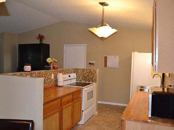 Kitchen is open to the vaulted living room.