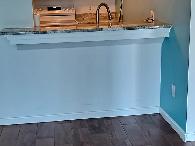 View from L.R. of breakfast bar into kitchen.