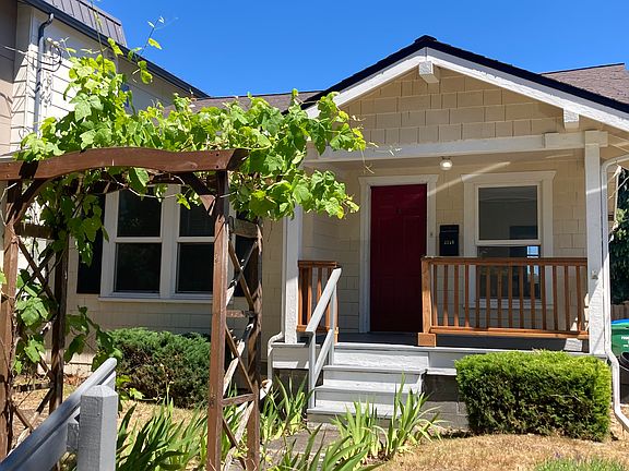 Front entry with grape arbor and porch. NOTE: The front yard to be fully renovated with new low-maintenance, water-wise landscaping & to be completed by October 1st.