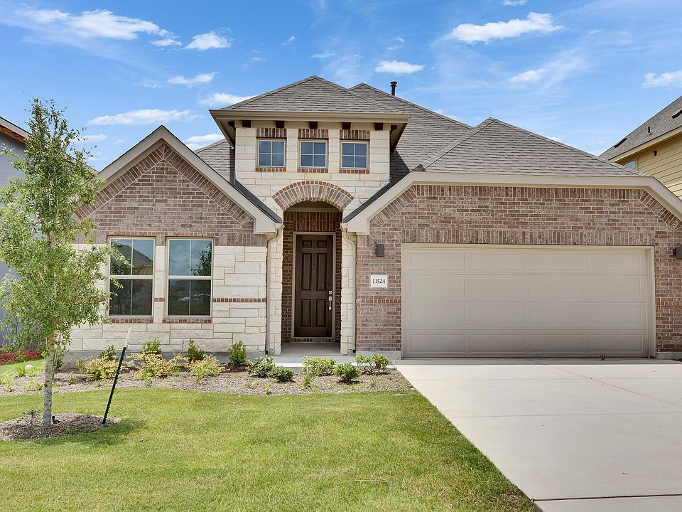 Sophisticated brick and stone facade, gabled roof, spacious layout. Located in the prestigious Briar