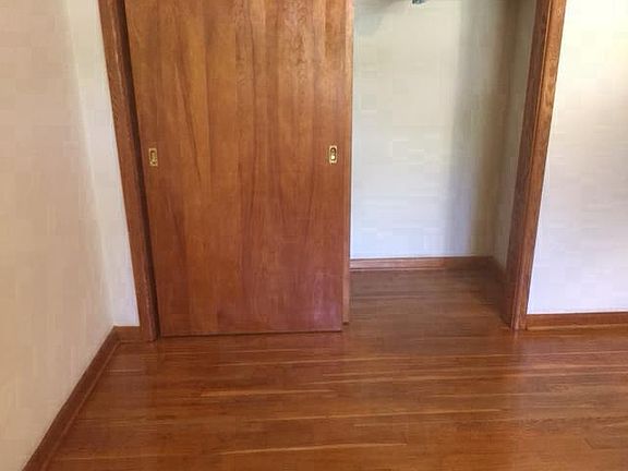 Bed room 2 and closet with wooden floor.
