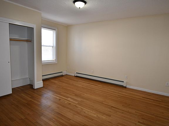 bedroom with hardwood and large closet