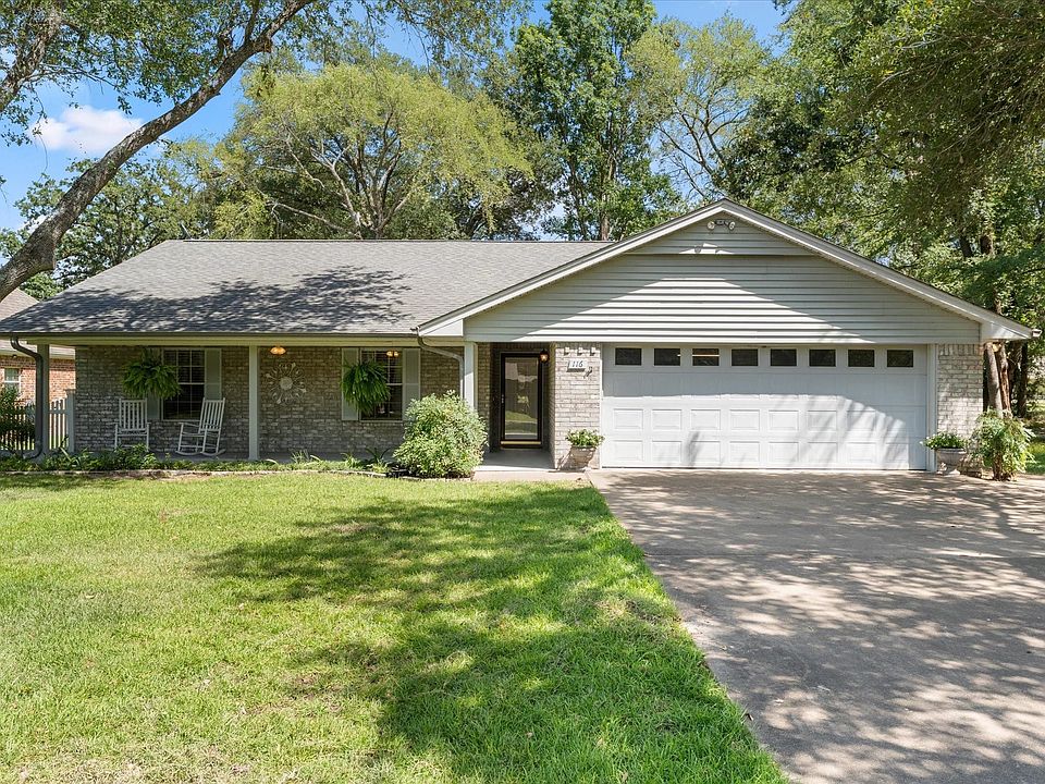 Brick and siding exterior with a covered front porch featuring white columns and a gray shingle roof