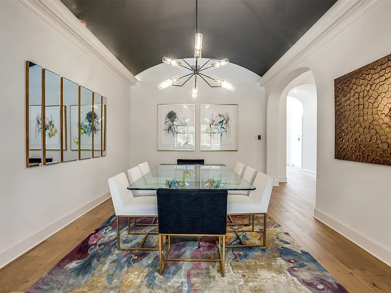 Vaulted ceiling with dark accent paint and crown molding
