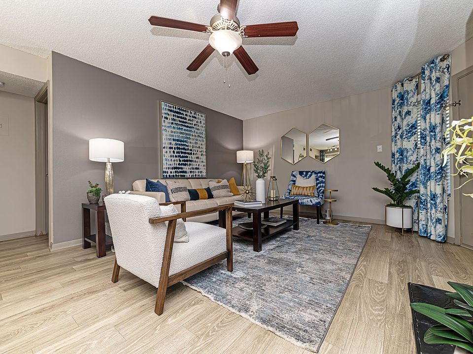 Spacious living room with hardwood-style flooring and overhead lighting