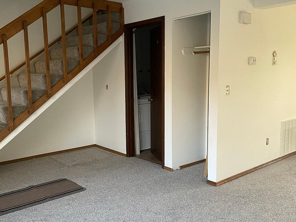 Front door at the other end of the carpet runner, half-bath, coat closet