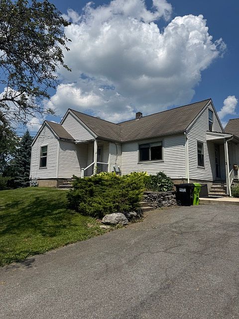 Front of house with front and side porch entries