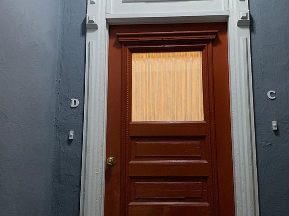 Front door to private entrance shared with apartment C to the right, apartment D is on the left side of the main entrance area.