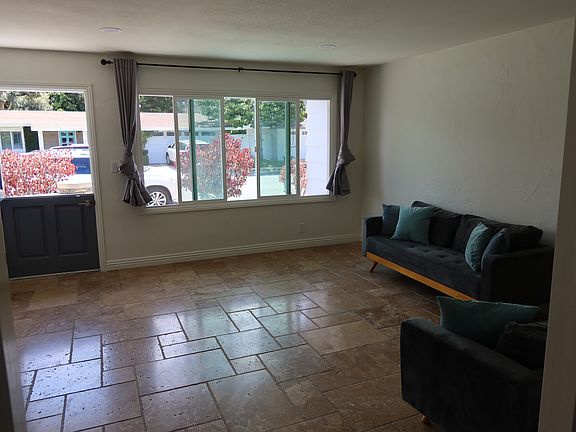 Living room and front windows and doors view from the dining room.