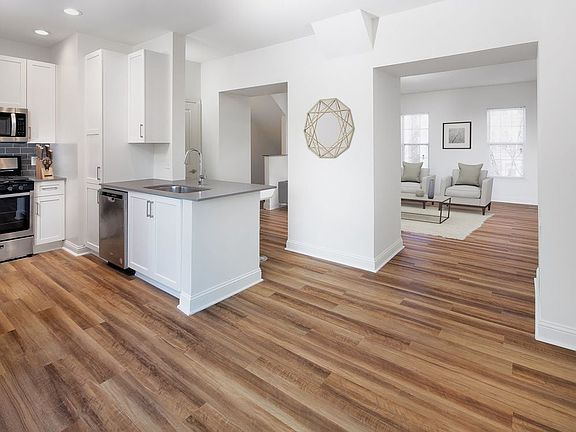 Kitchen, living, and dining areas with hard surface flooring