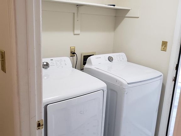 garage leads to laundry room with washer and dryer and space for storage