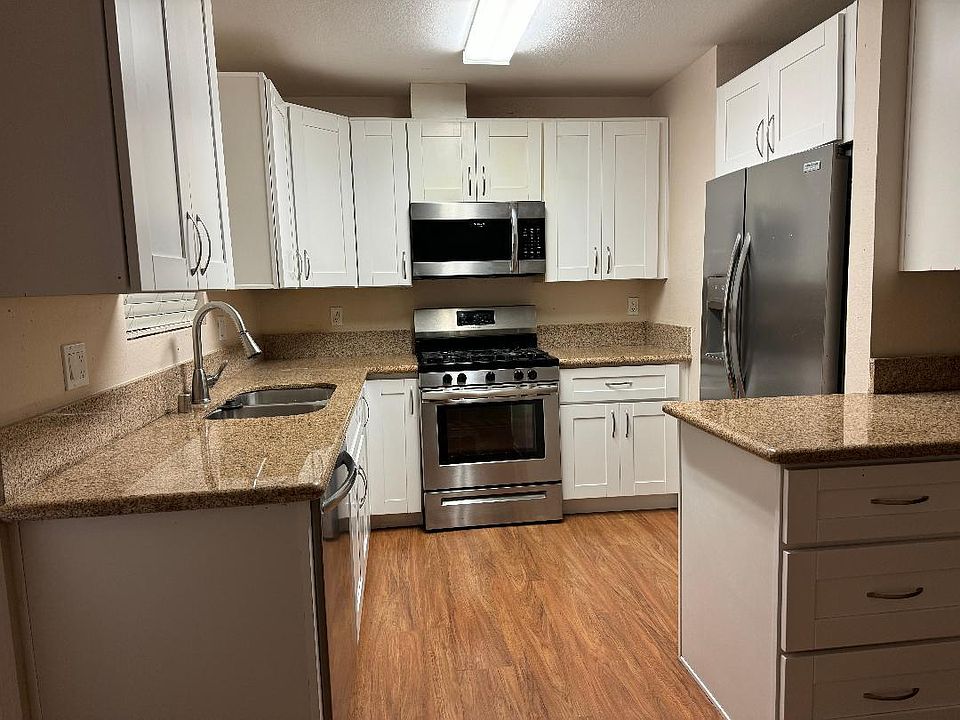 Kitchen includes garbage disposal, gas range, microwave, side by side fridge, dishwasher, lots of cupboard space.