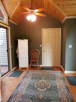 The vaulted wood ceilings bring warmth to the side door foyer and make you feel good as you enter this house...