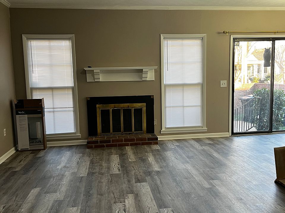Living room with small eating area and exit to private patio.