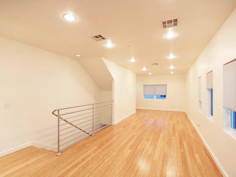 15. Staircase Landing with Dining and Living Rooms Looking East