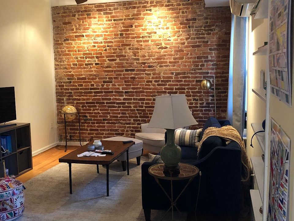 Spacious living room with exposed brick