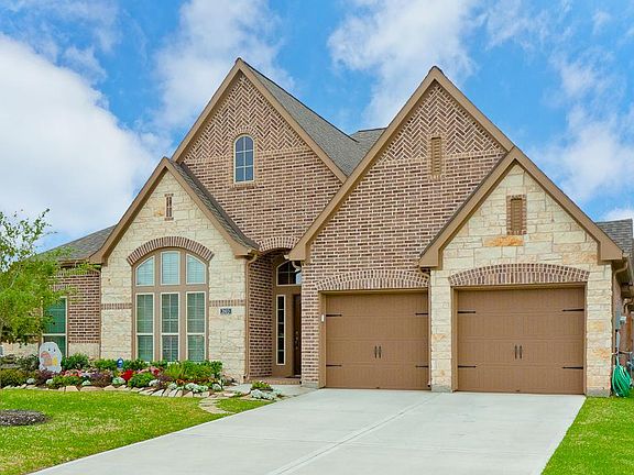 Stone elevation and his/her garages with one tandem for third space!