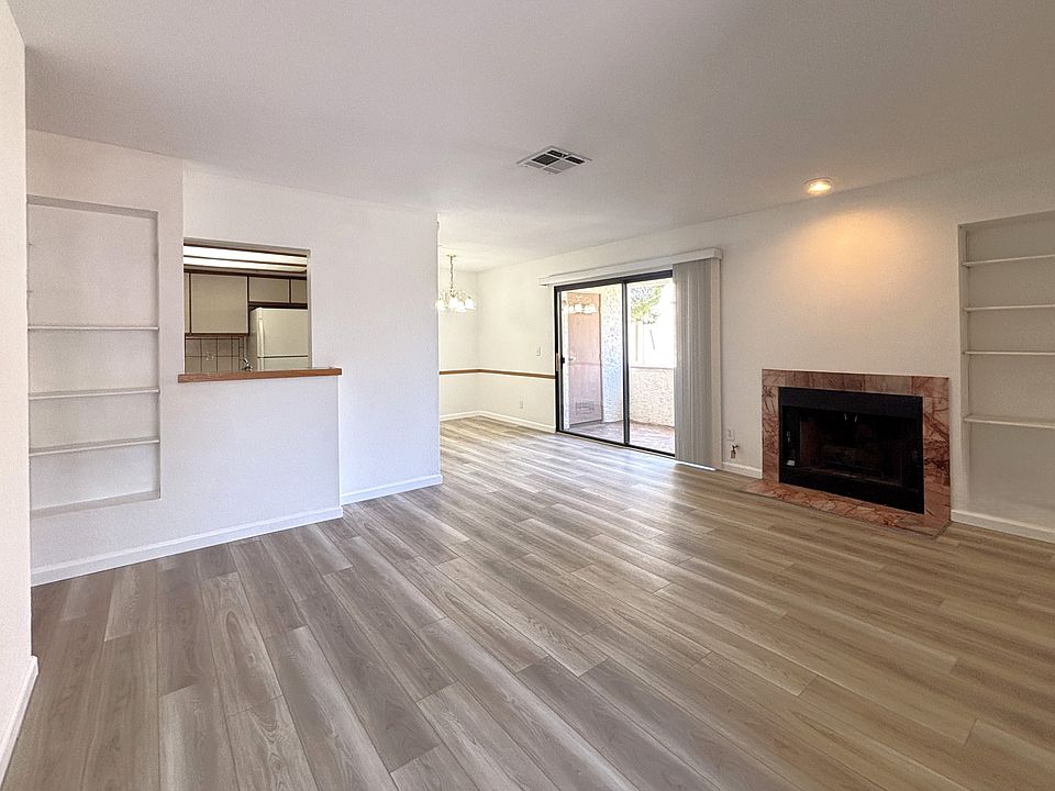 Wide open floor plan for the entry way, living room with fireplace, dining room and kitchen.