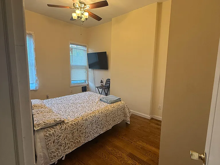 Private bedroom 2, hardwood floors, TV, ceiling fan, two windows for natural light, AC, drawer, room for small desk.