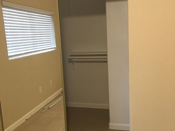 Enormous wak-in closet with mirrored sliding doors