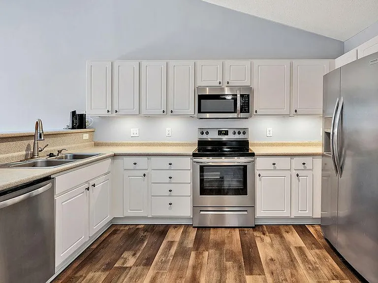 Kitchen with dishwasher, fridge, microwave, and oven&stove