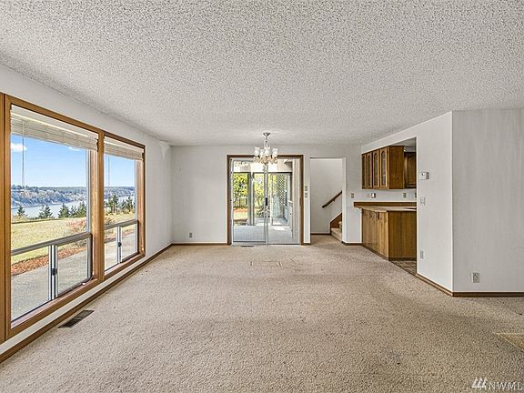 The Spacious Living Room has a bank of 3 windows facing the View of the Mountains and the Narrows. Slider at the end opens to the Large Sun Room. The wall on the right is the back side of the kitchen - it would be great to open it to the living area! 