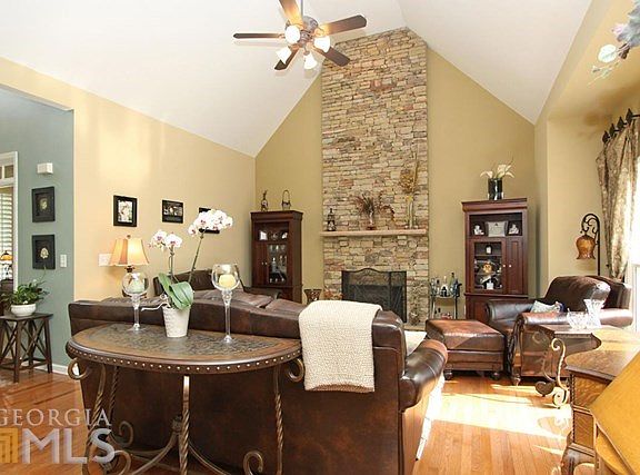 Open floor plan with hardwood floors and plantation shutters