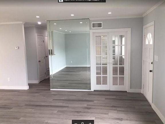 Entry way into the family room with access to bedroom 3 or a home office behind the French Doors.