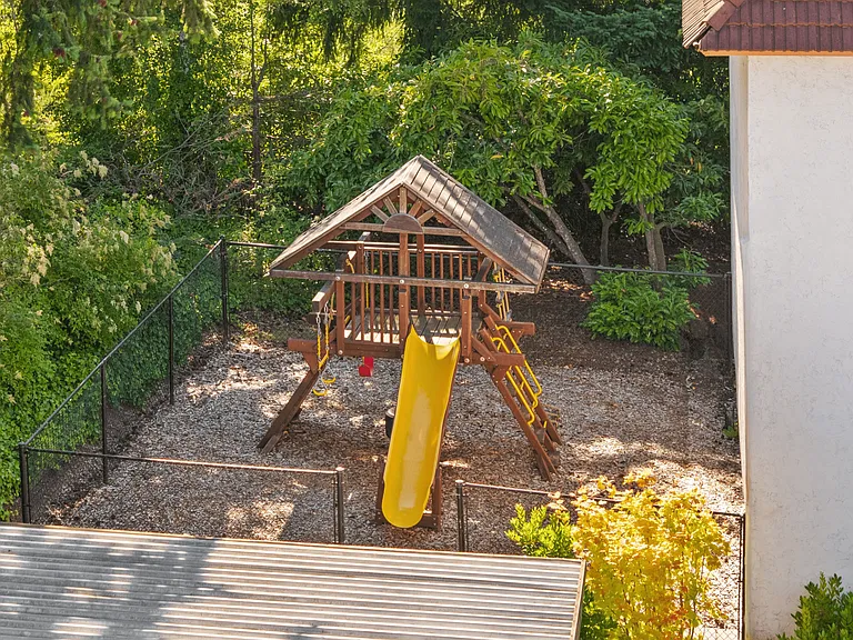 A cozy, shaded playground designed for safe, outdoor fun.