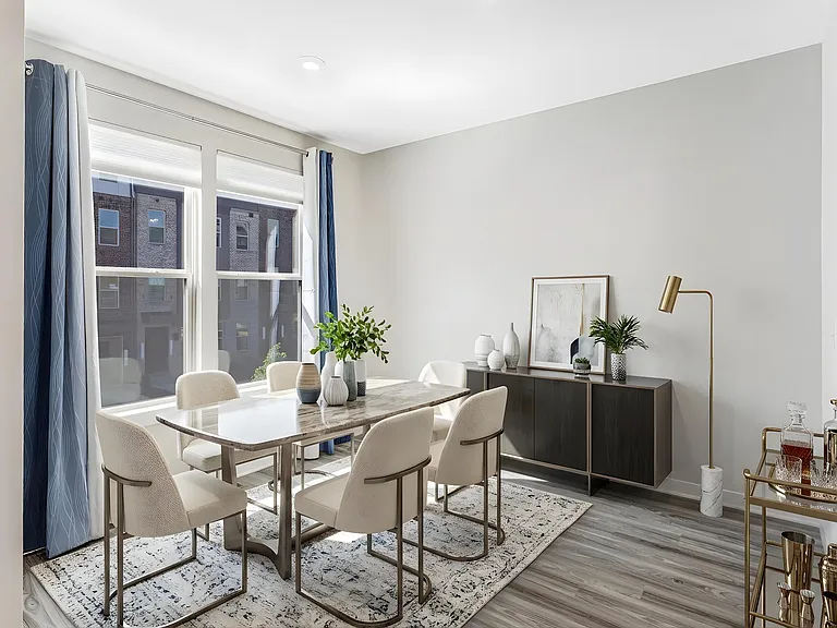 The inviting dining area flows effortlessly within the open-concept layout, creating a welcoming space for memorable meals and gatherings. Virtually staged.