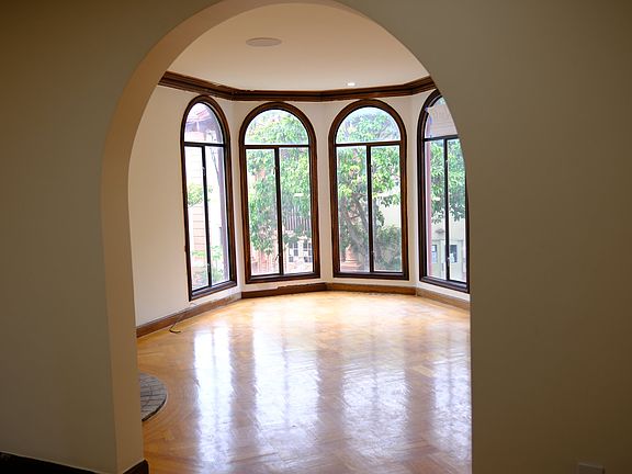 Through the arch: the living room and its bay of arched windows
