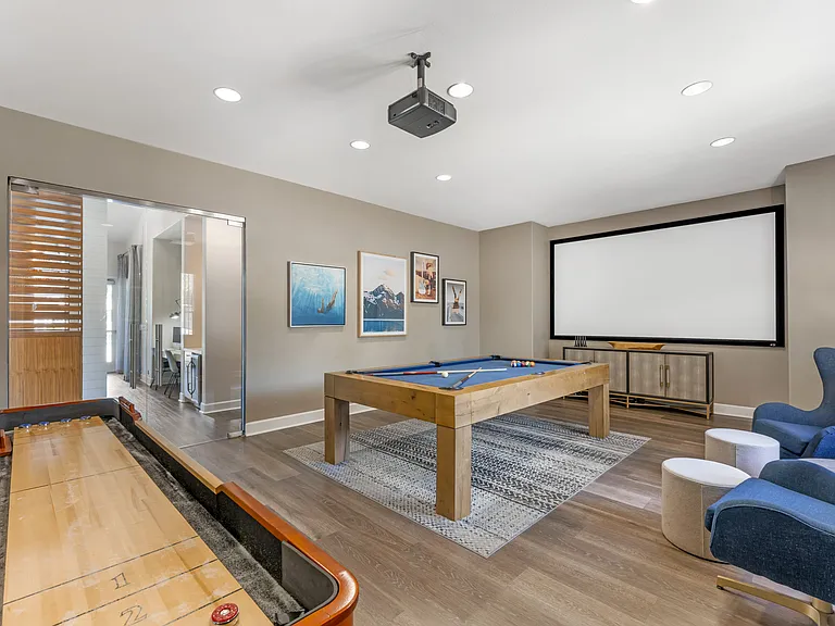 The clubhouse offers a variety of amenities, including a rec room with a pool table, TV, and shuffleboardperfect for relaxing and socializing at Ascent at the Galleria.