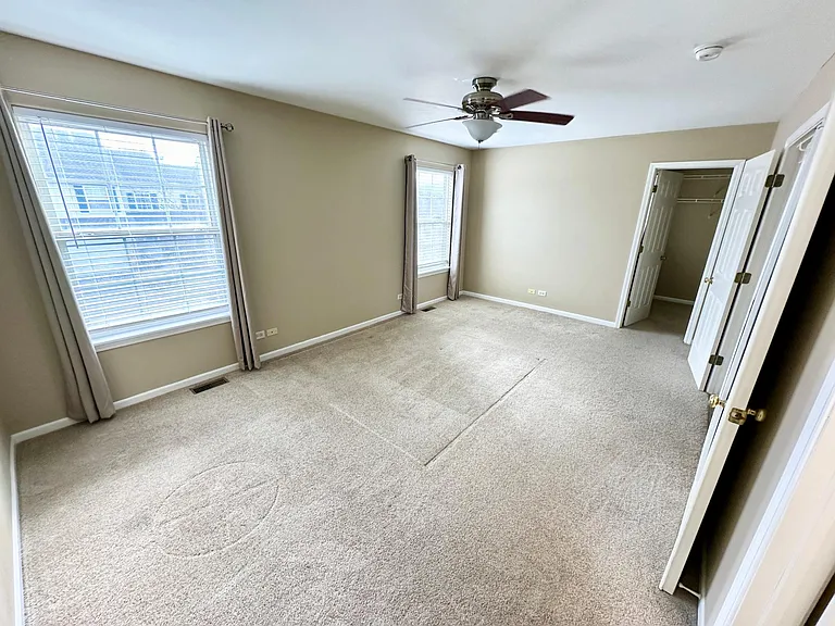 primary bedroom on the second floor featuring a walk-in closet