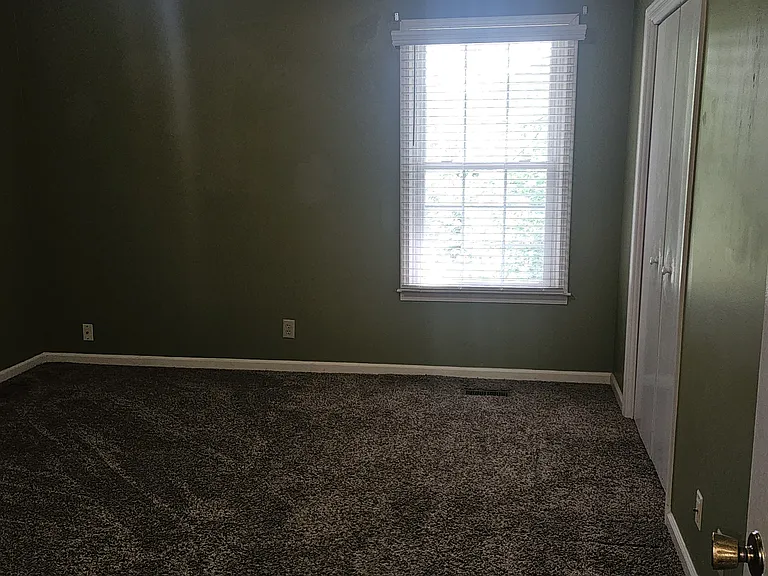 Primary bedroom with walk-in closet and attached 1/2 bath.