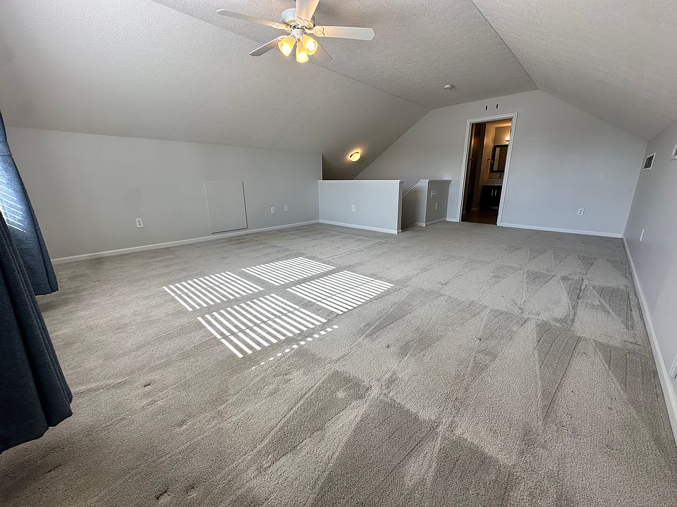 with bathroom, walk-in closet, and storage room