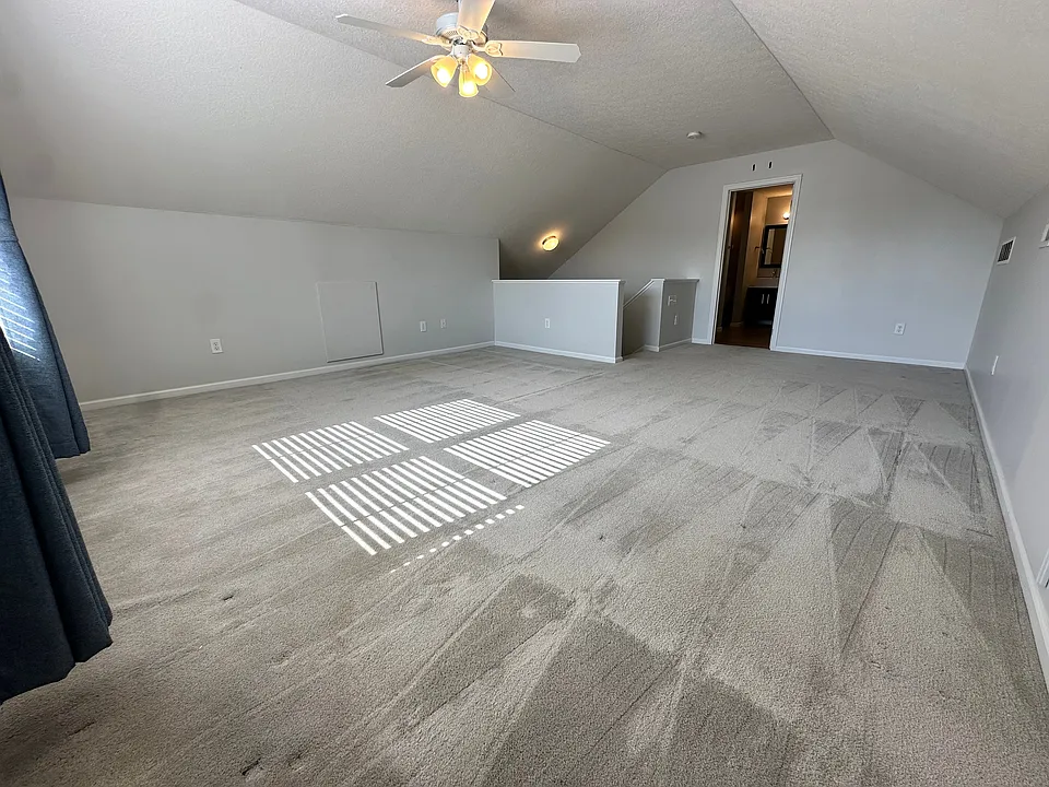 with bathroom, walk-in closet, and storage room