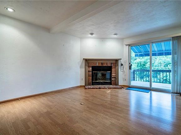 19x13 Family area with gas fireplace. Large sliding glass doors to rear deck let in natural light.