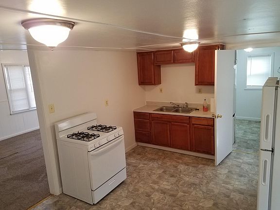 Kitchen. New stove, Refrigerator, Cabinets and floor.