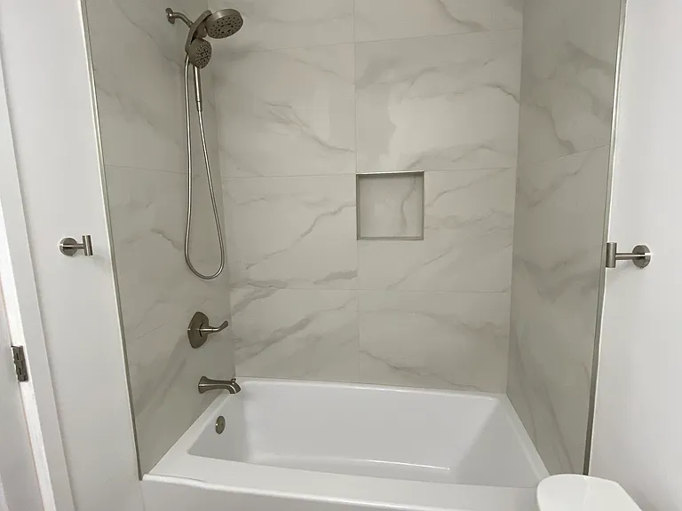 Hallway bathroom with deep soaking bathtub